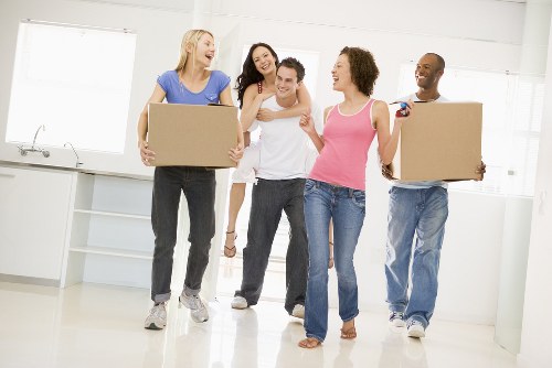 Student removals team handling boxes in Bow street outside a flat