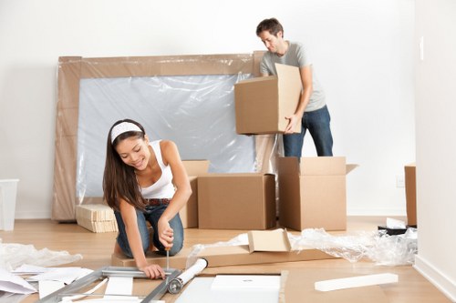 Removal team planning a flat move in Bow with boxes and furniture