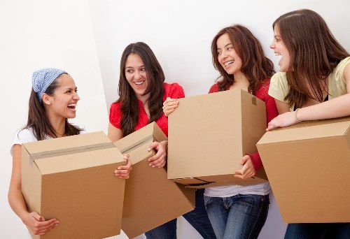 Professional movers handling household belongings in East London