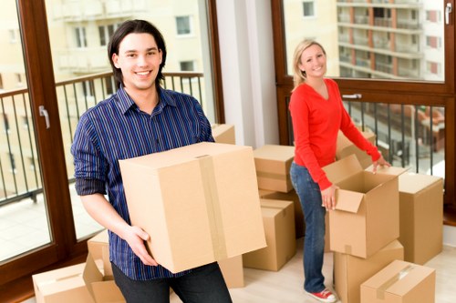 Removal company staff handling furniture carefully during transport