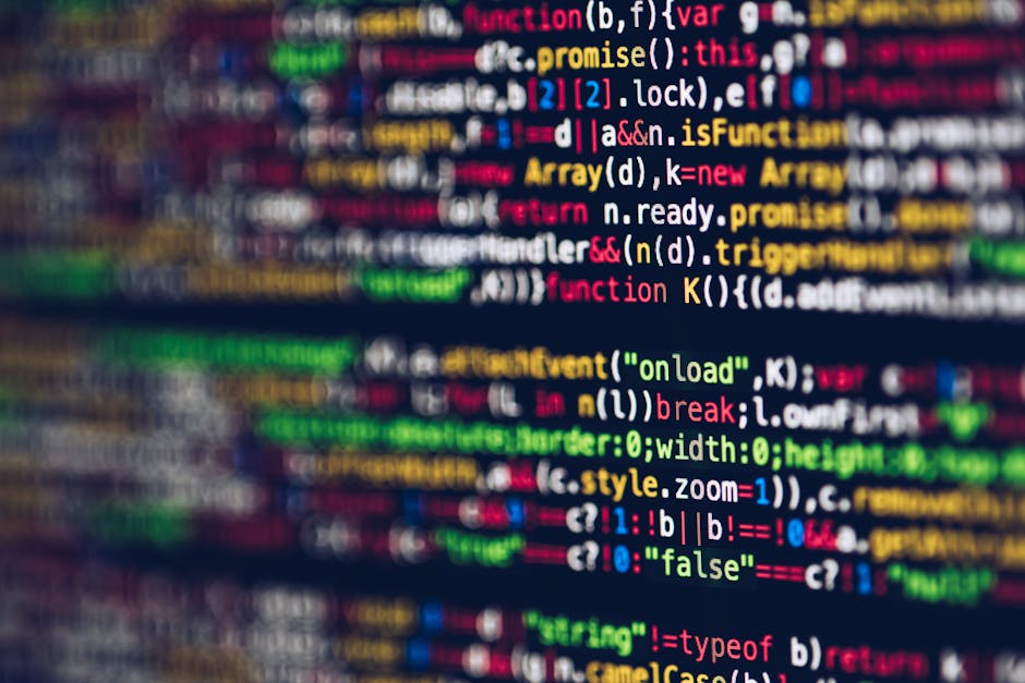 Close-up image of a computer screen displaying colorful lines of code in various programming languages, including HTML, JavaScript, and CSS. The code is out of focus, with blurred text and syntax high